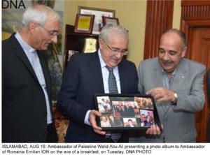 ISLAMABAD, AUG 16: Ambassador of Palestine Walid Abu Ali presenting a photo album to Ambassador of Romania Emilian ION on the eve of a breakfast, on Tuesday. DNA PHOTO