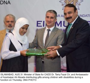 ISLAMABAD, AUG 31: Minister of State for CADD Dr. Tariq Fazal Ch. and Ambassador of Azerbaijan Ali Alizada distributing gifts among children with disabilities during a function on Thursday. DNA PHOTO