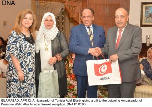 ISLAMABAD, APR 12: Ambassador of Tunisia Adel Elarbi giving a gift to the outgoing Ambassador of Palestine Walid Abu Ali at a farewell reception. DNA PHOTO