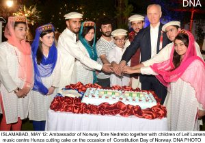 ISLAMABAD, MAY 12: Ambassador of Norway Tore Nedrebo together with children of Leif Larsen music centre Hunza cutting cake on the occasion of Constitution Day of Norway. DNA PHOTO