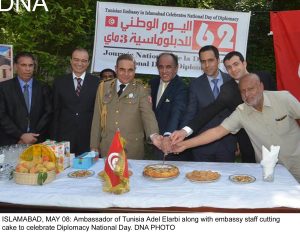 ISLAMABAD, MAY 08: Ambassador of Tunisia Adel Elarbi along with embassy staff cutting cake to celebrate Diplomacy National Day. DNA PHOTO