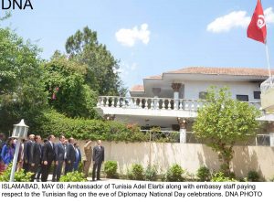 ISLAMABAD, MAY 08: Ambassador of Tunisia Adel Elarbi along with embassy staff paying  respect to the Tunisian flag on the eve of Diplomacy National Day celebrations. DNA PHOTO