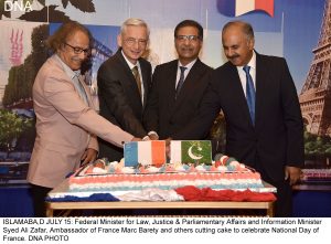 ISLAMABA,D JULY 15: Federal Minister for Law, Justice & Parliamentary Affairs and Information Minister Syed Ali Zafar, Ambassador of France Marc Barety and others cutting cake to celebrate National Day of France. DNA PHOTO