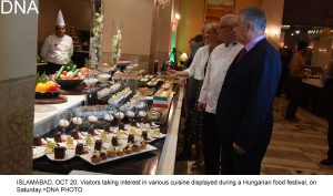 ISLAMABAD, OCT 20: Visitors taking interest in various cuisine displayed during a Hungarian food festival, on Saturday.=DNA PHOTO