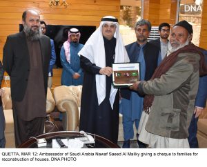 QUETTA, MAR 12: Ambassador of Saudi Arabia Nawaf Saeed Al Maliky giving a cheque to families for reconstruction of houses. DNA PHOTO