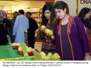 ISLAMABAD, JUL 26: Mango lovers taking interest in various kinds of mangoes during Mango Festival at Centaurus Mall, on Friday.=DNA PHOTO